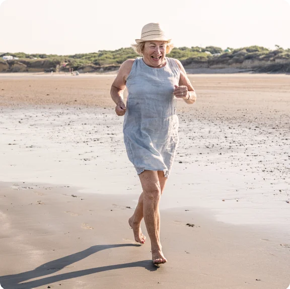 A person running on a beach.