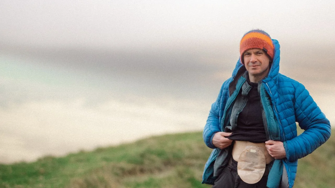 a person wearing a blue jacket and a red beanie