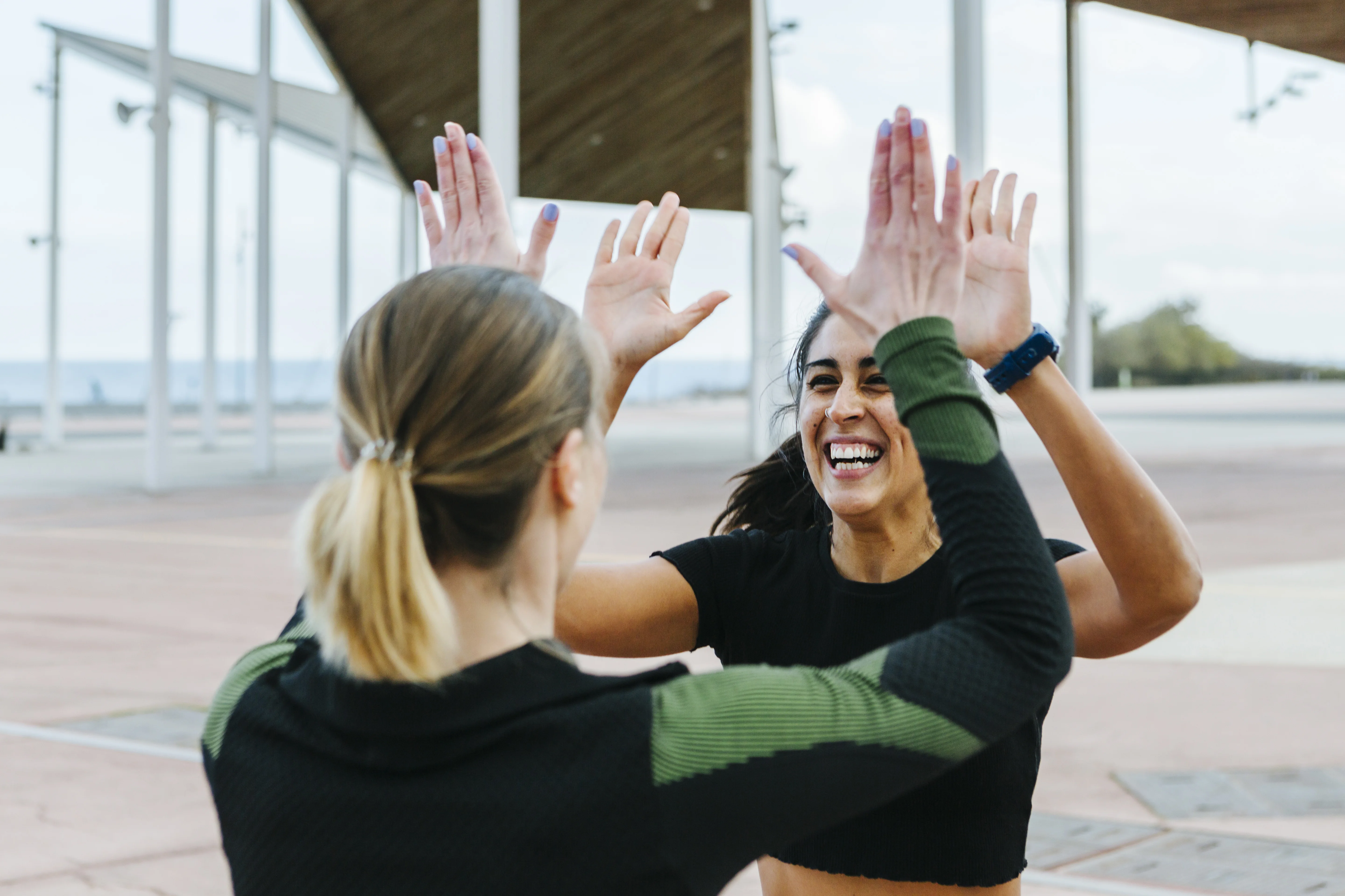 Two women giving each other a high five